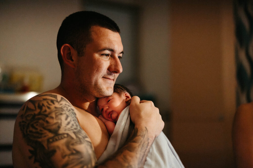 A father holding his new baby 