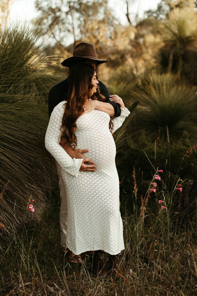 Maternity shoot in the field with a couple