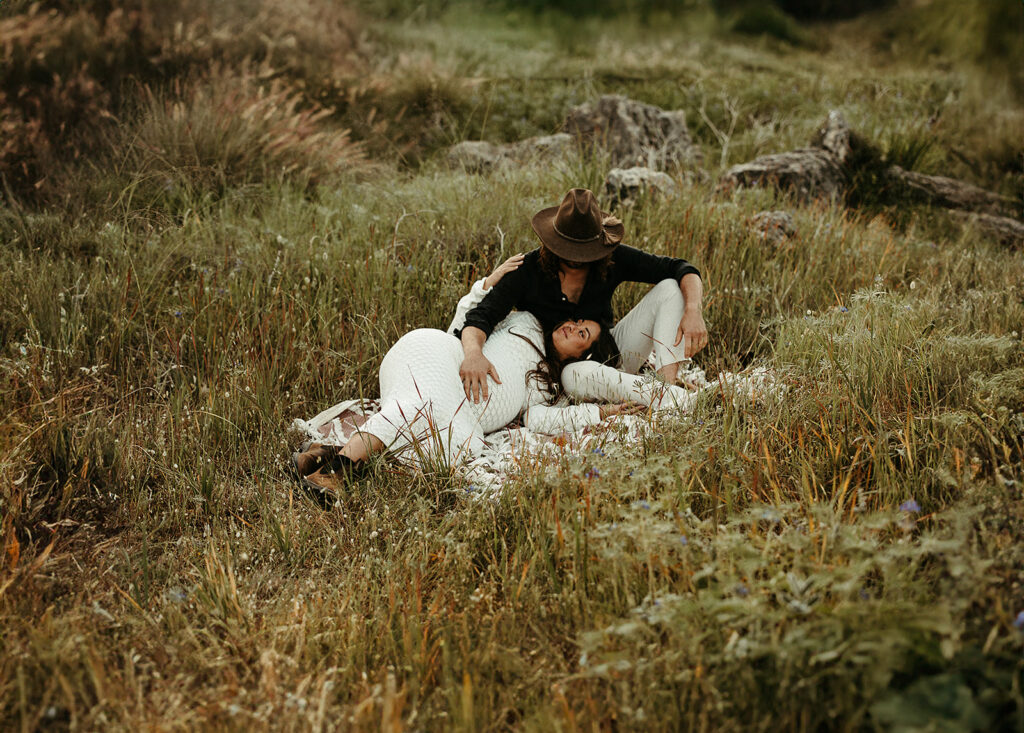 A pregnant mother and father in a field on their maternity shoot